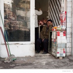 Cigarette seller napping, Enqelaab Street, Tehran